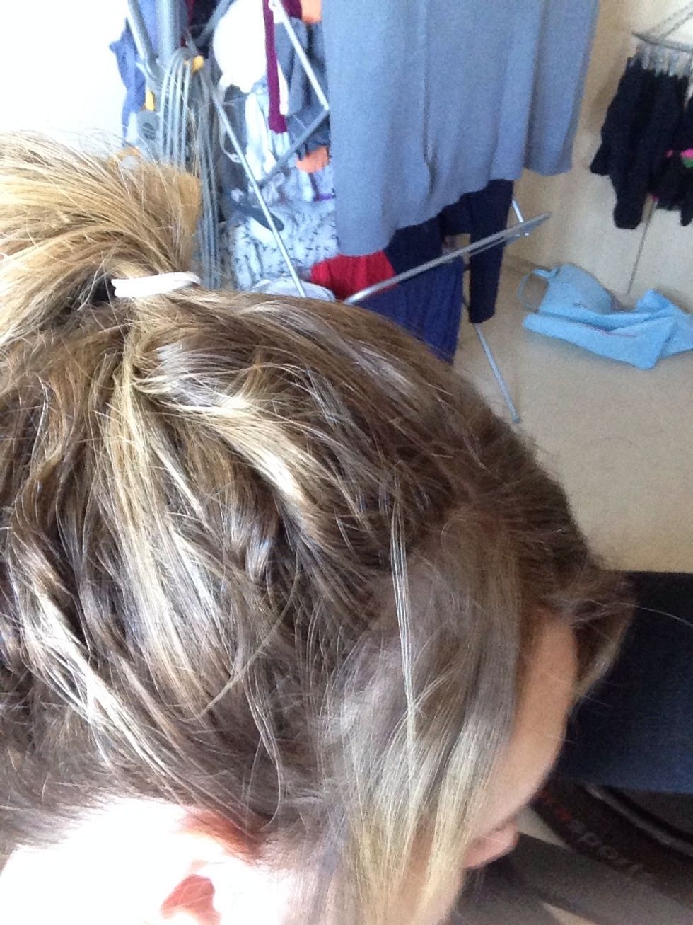 Tie your hair in a pony at whatever height you want