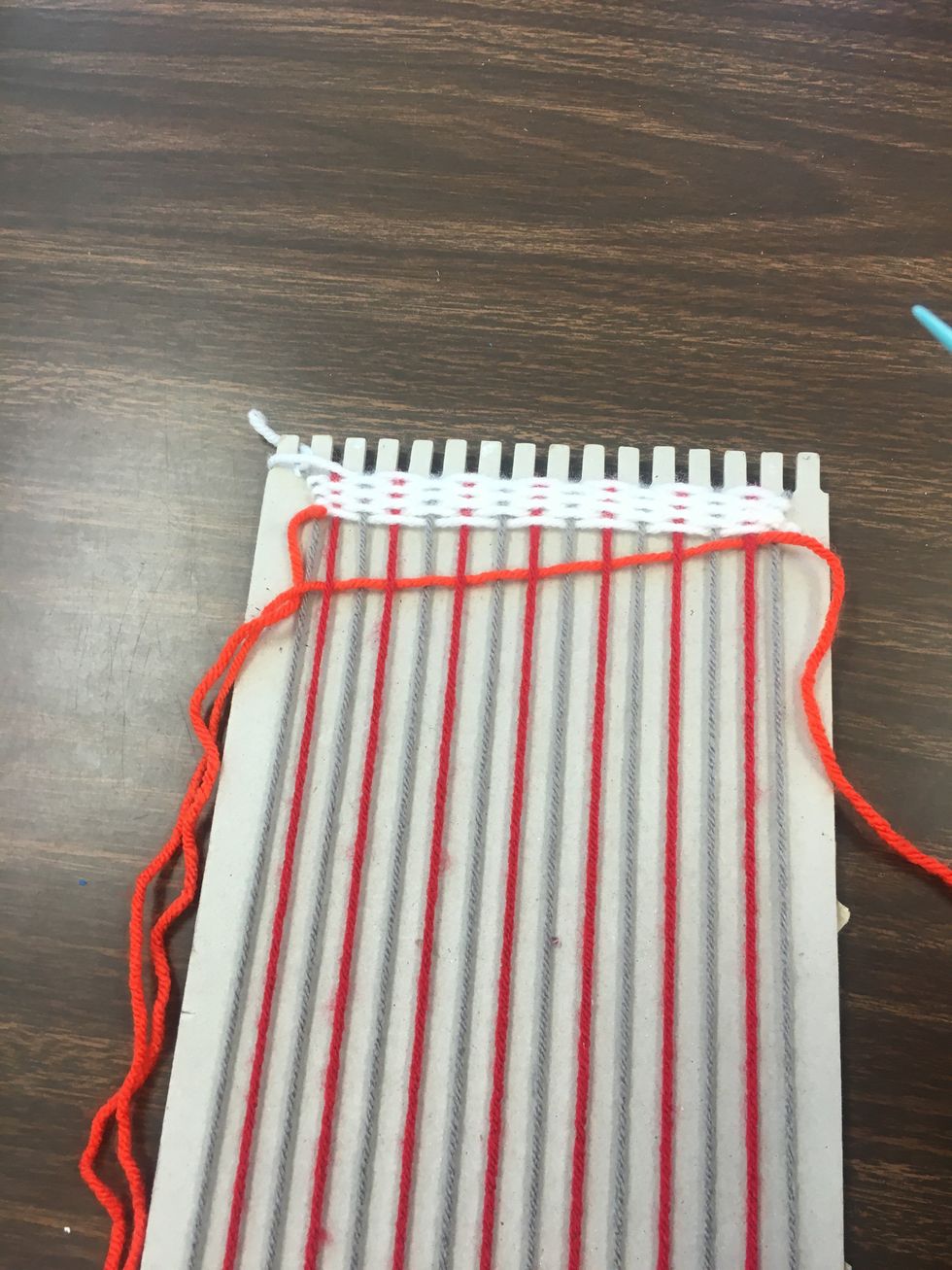 Tie your needle to the end, and resume weaving as you did with the first color.