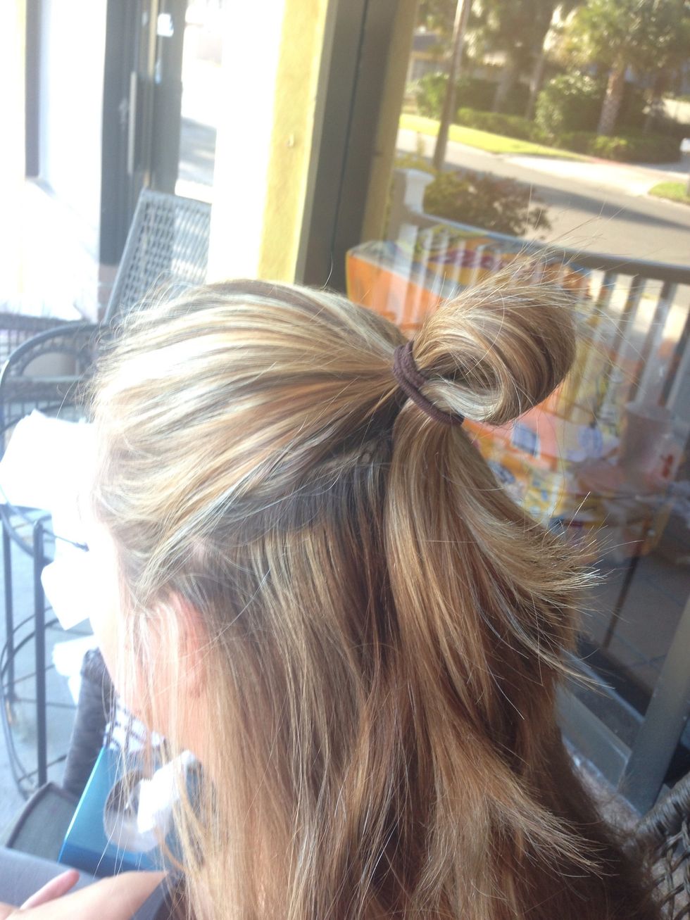 Tie your ponytail but leave a small loop at the end. (This will be the base of your bow)