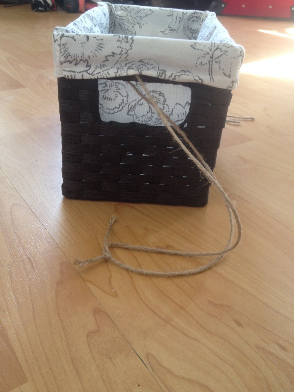 Tie your rope or ribbon through the sides of your basket at the length you want it to hang. I recommend about a foot.