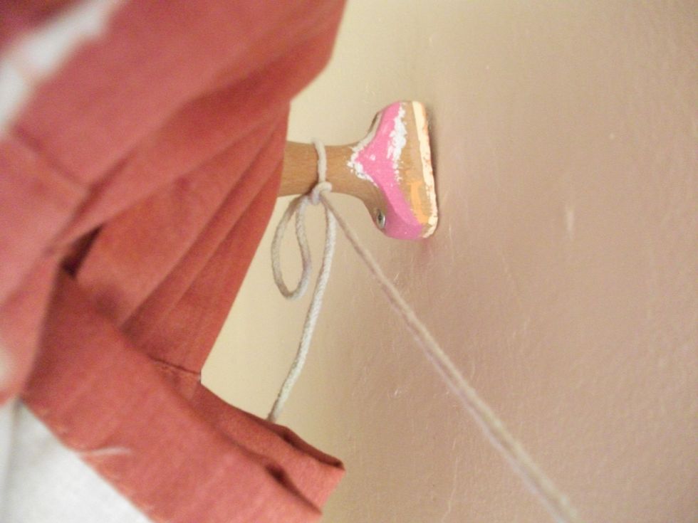 Tie your string/rope across these bits on the frame of the curtains.