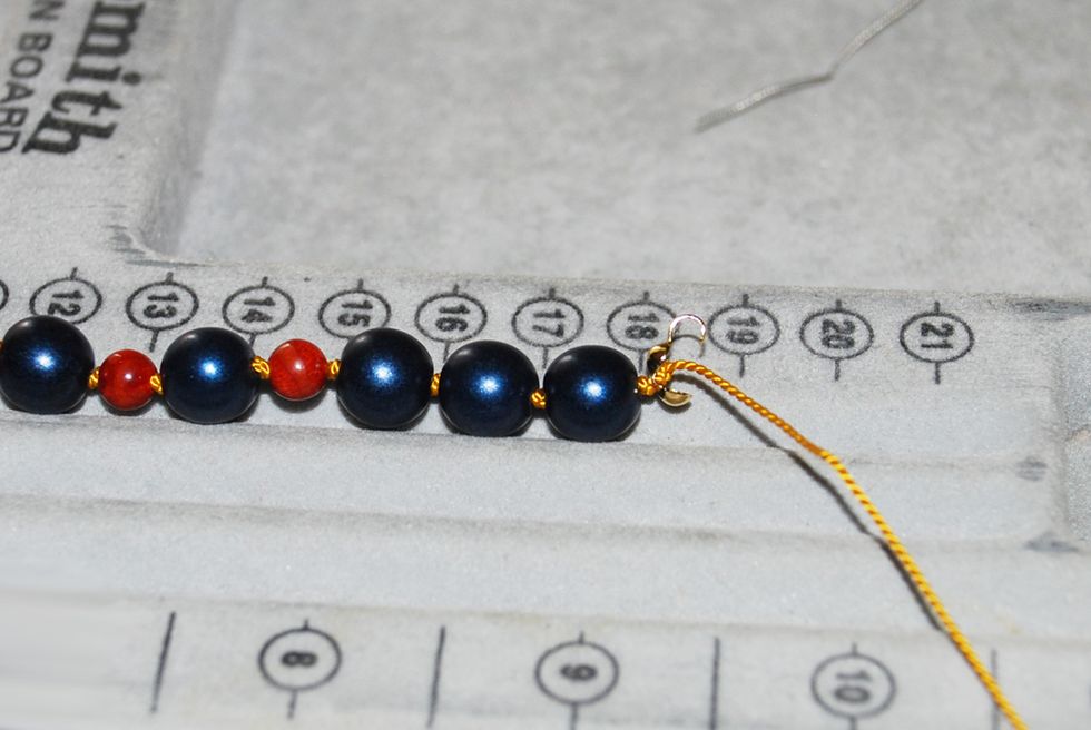 Tie your very last knot on the other side of the end-cap, using the same technique as you did with all your other knots.