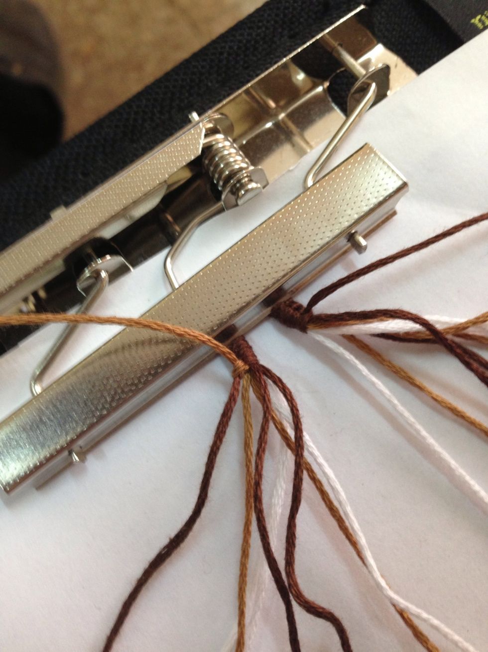 Tighten it to the top! Now do the exact same knot again. Same strings, same tie! Each knot we do, we're going to tie it twice. Cool? Cool.