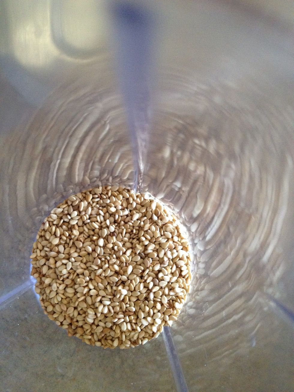 Till this is cooking add roasted sesame seeds,coconut powder and peanuts and make a powdered mix now add water and blend it again for a minute