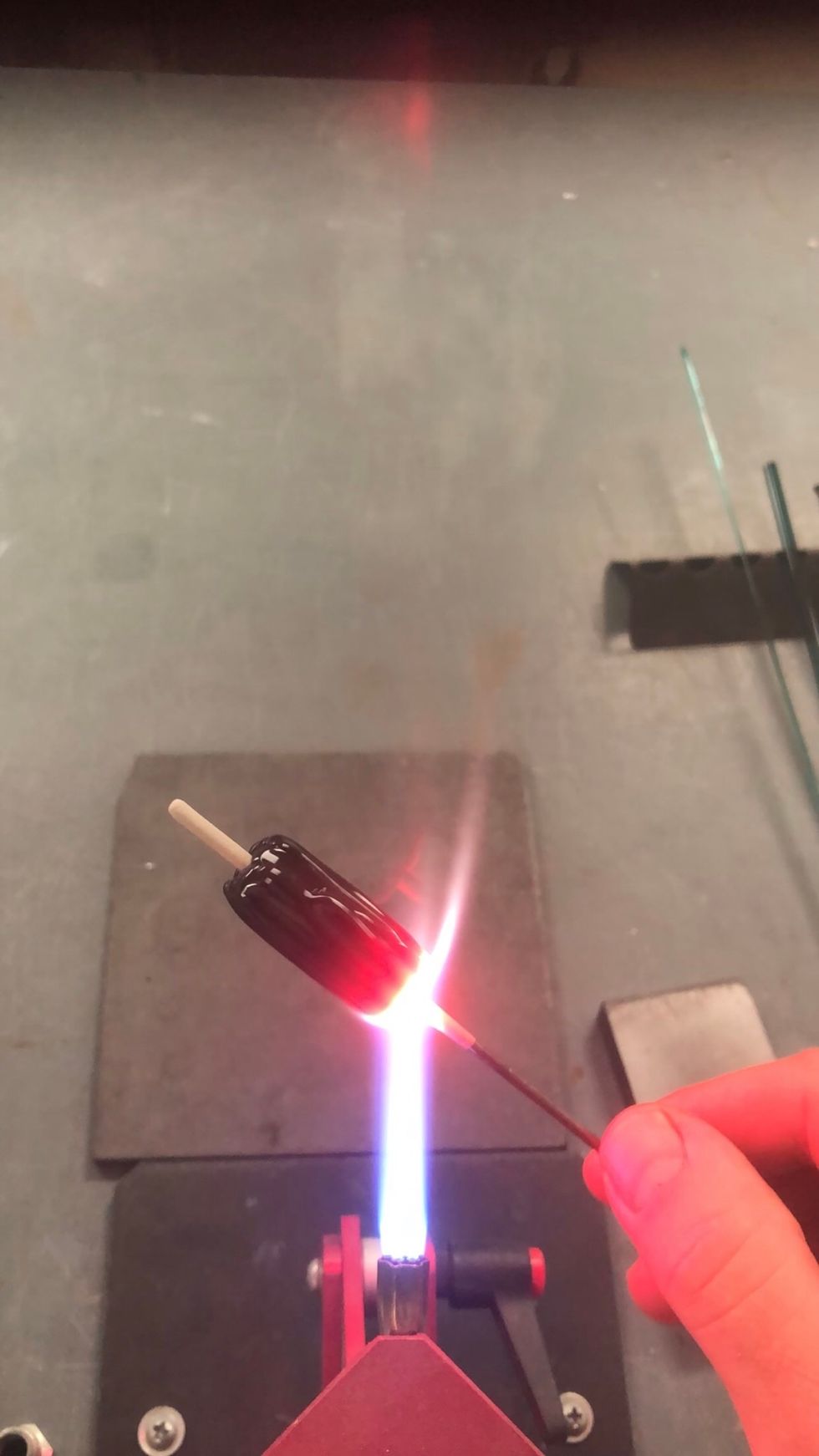 Tilt the bead so that the end gets hot enough to flow a bit. Let it just start to move. That will allow the black coat to cover the edges and end.