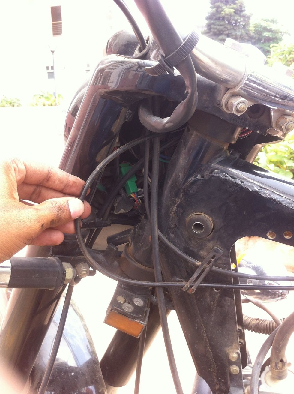 Tilt the handle bar away from you and pull the cable as shown in picture.