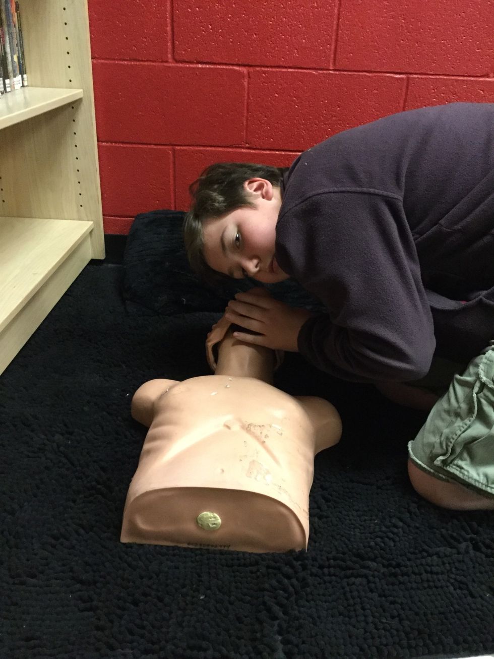 Tilt the head and listen for breathing, if not begin CPR.