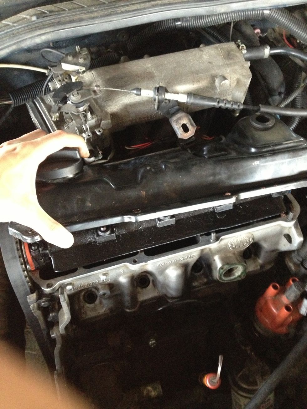 Tilt the head cover back and lift it out at an angle (may need to shimmy it out if pinched by the intake)