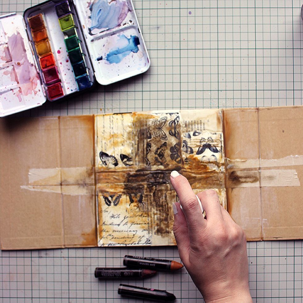 Time to add color! Use both Watercolor Confections and Oil Pastels to add rusty, vintage colors to your project. Add a mist of water on top and let the colors run.