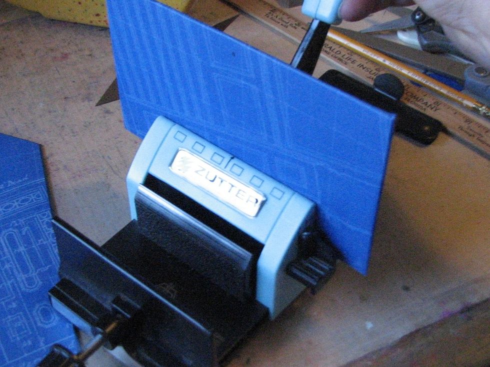 Time to bind - I start off by punching holes in the doors to ensure proper placement on the base. Center the door/cover and punch.