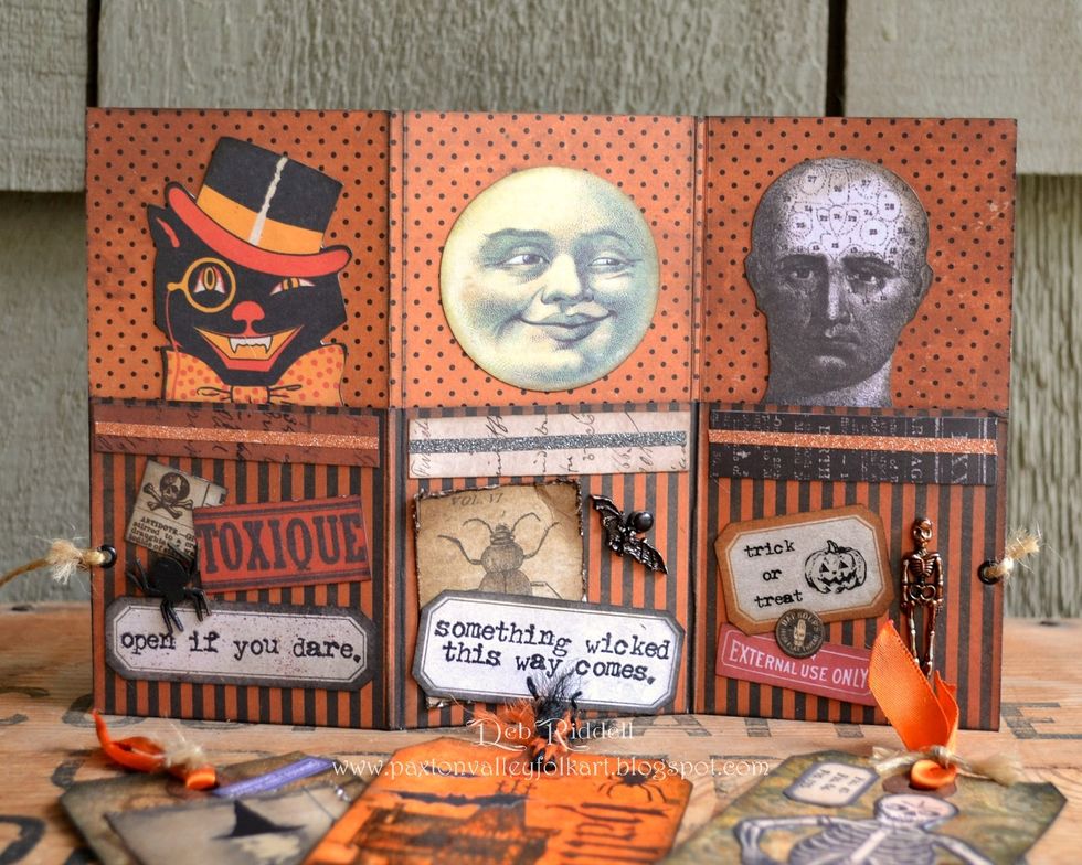 Time to embellish! Adhere the three images (cat, moon and phrenology head) from the Frightful Ephemera pack to the top of the pocket pages.