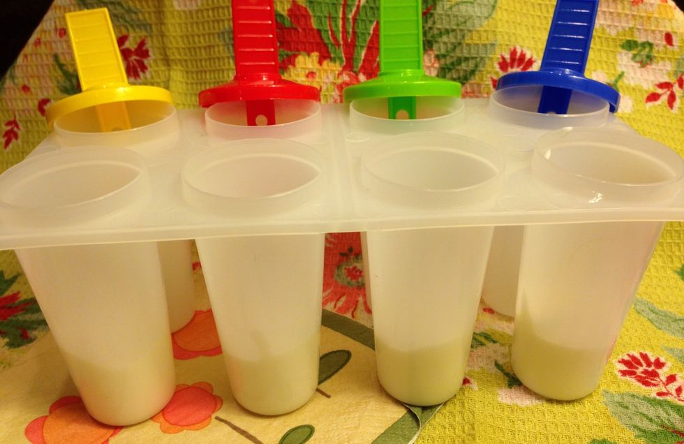 Time to layer the mixtures! Start by placing a dollop of the yogurt mixture at the bottom of each paper cup or ice-pop mold.