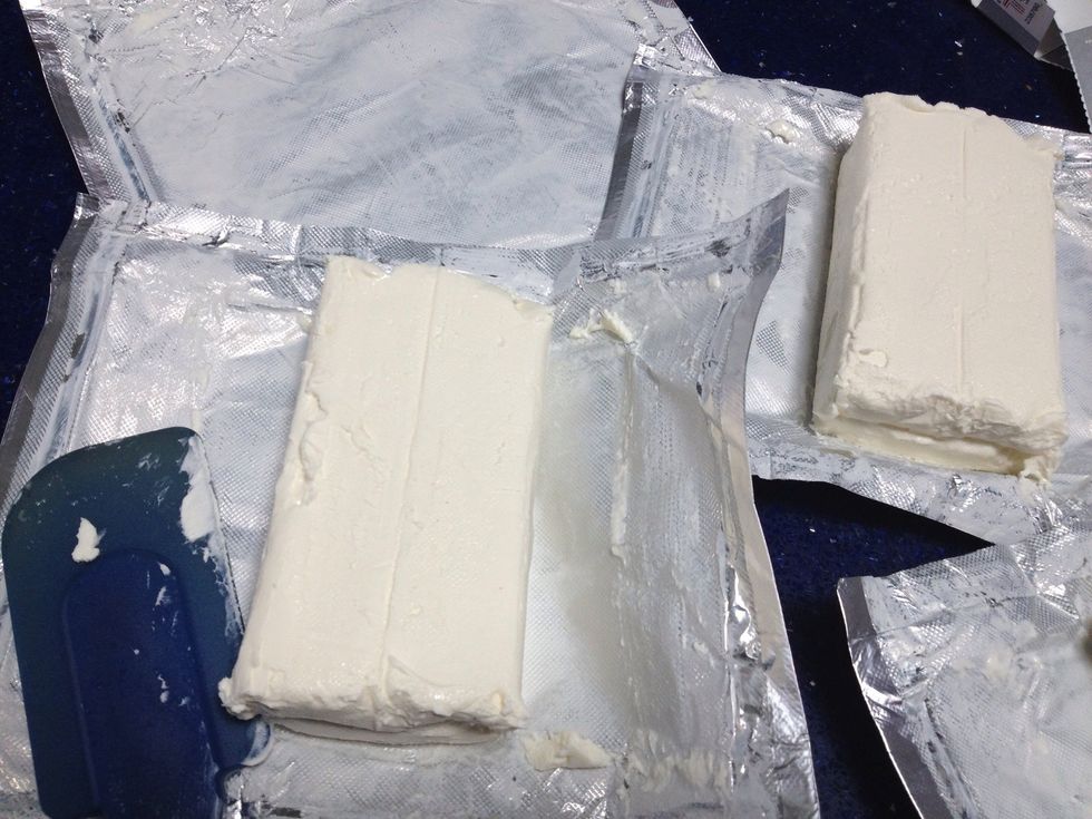 Time to start the batter! Open all your cream cheese packages that have hopefully reached room temperature. Use a rubber spatula to scrape ALL the cream cheese into your mixing bowl.