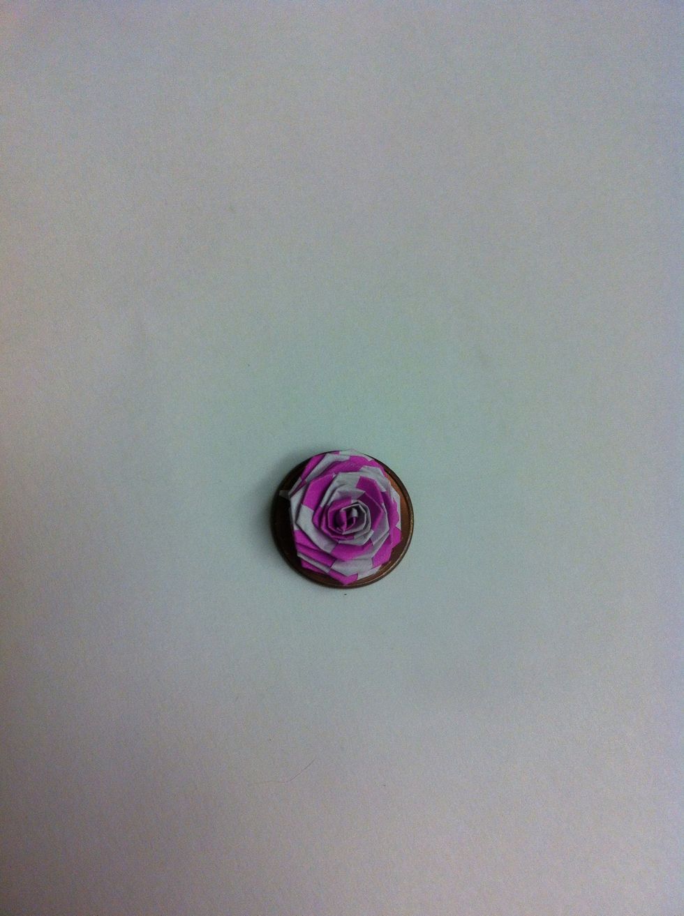 Tiny little fella setting on a penny. You can use your fingernail to try to round the petals back a bit for more realistic rose. I didn't do that to mine, though.