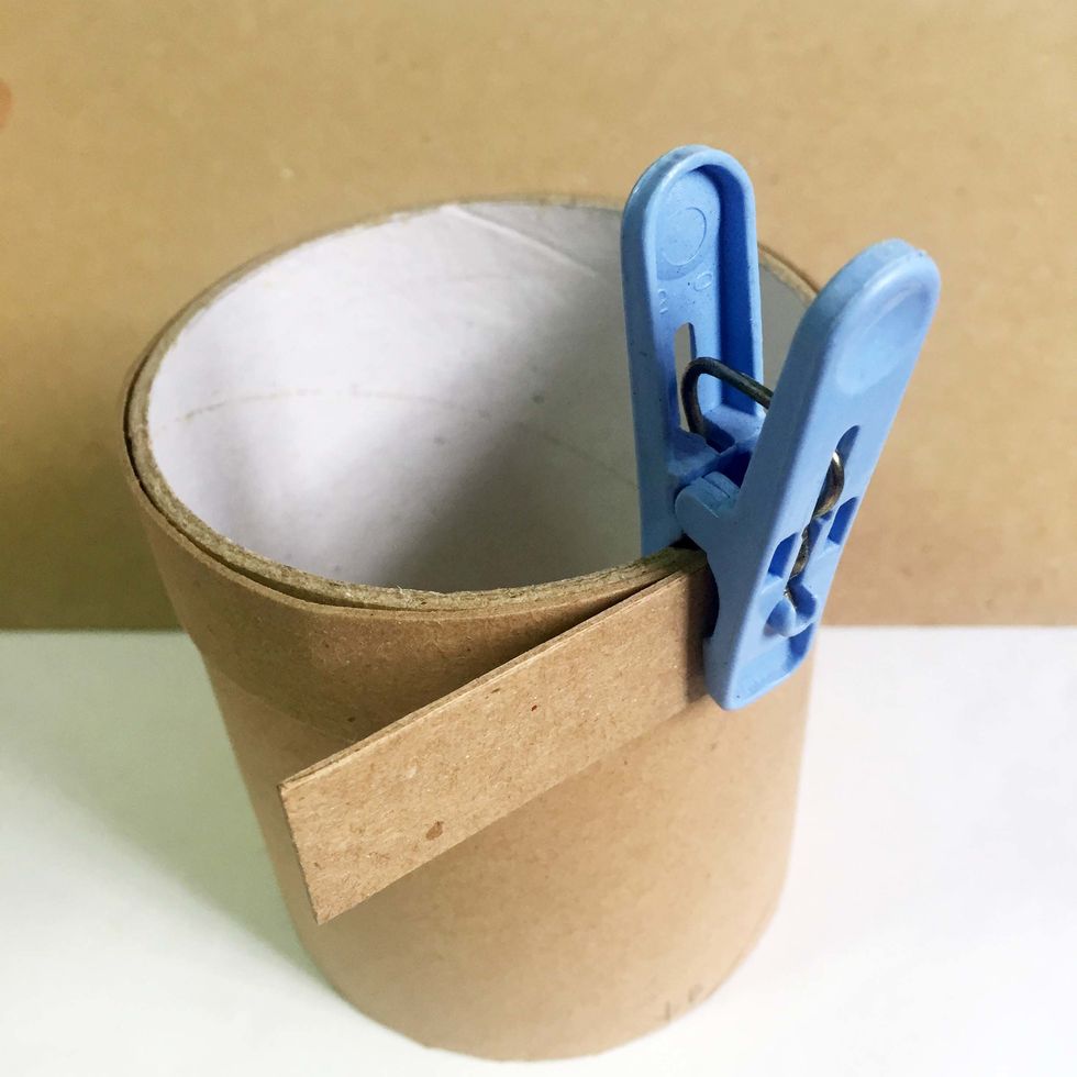 TIP: For easy assembly, secure the rim around the other toilet roll with a clothes peg and leave it to take shape while you work on the rest of the steps.