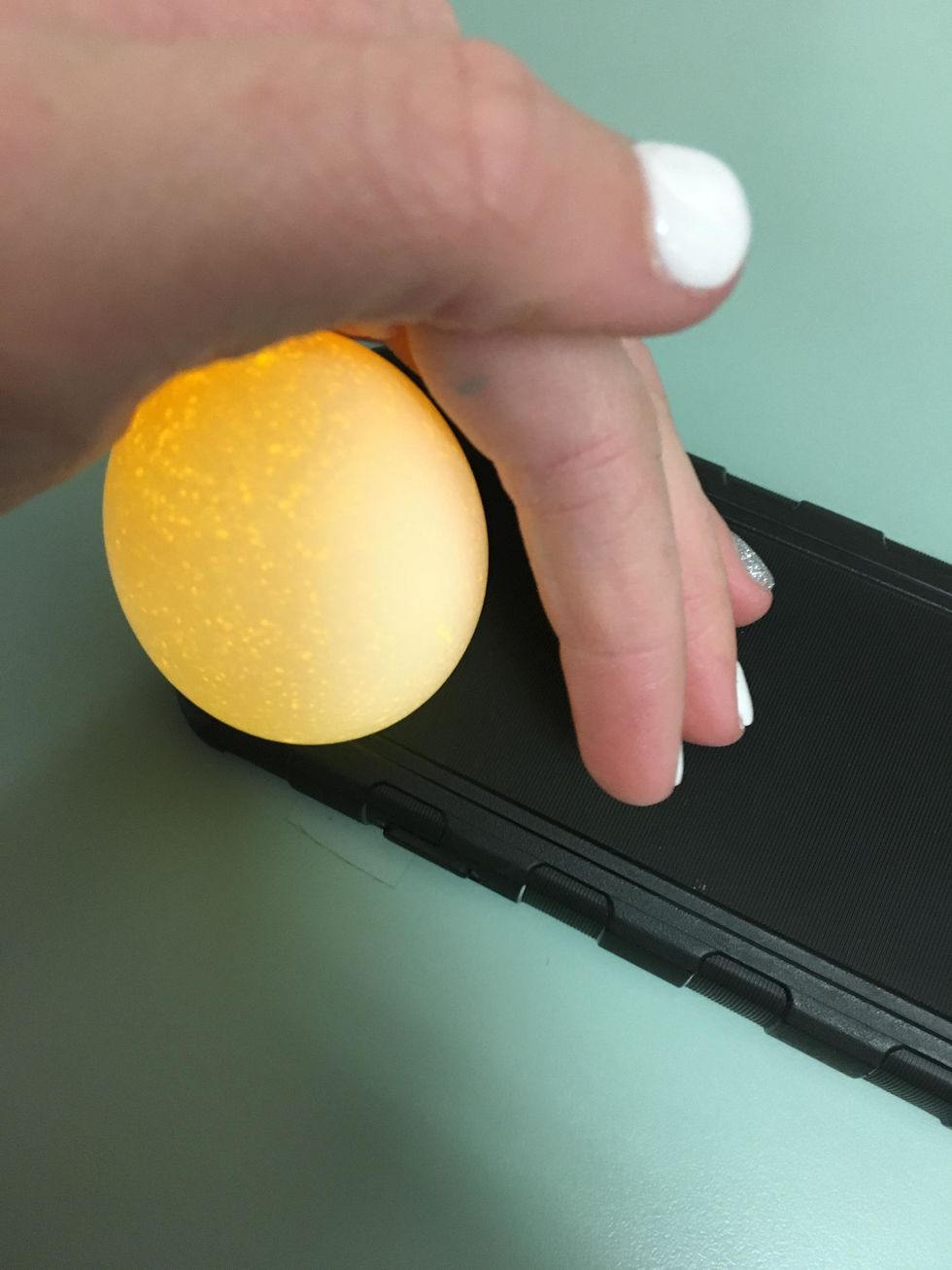Tip: In order to know if the egg has been scrambled, place it on top of a flashlight (you can use your phone flashlight). If the scrambled looks darker than a normal egg, then you have do it right!
