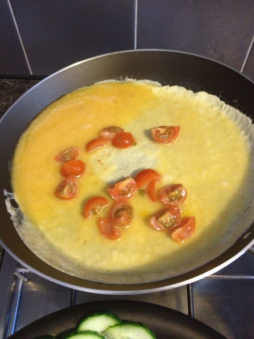 Tip the eggs to each side to spread the mixture around, and make the omelette larger...
