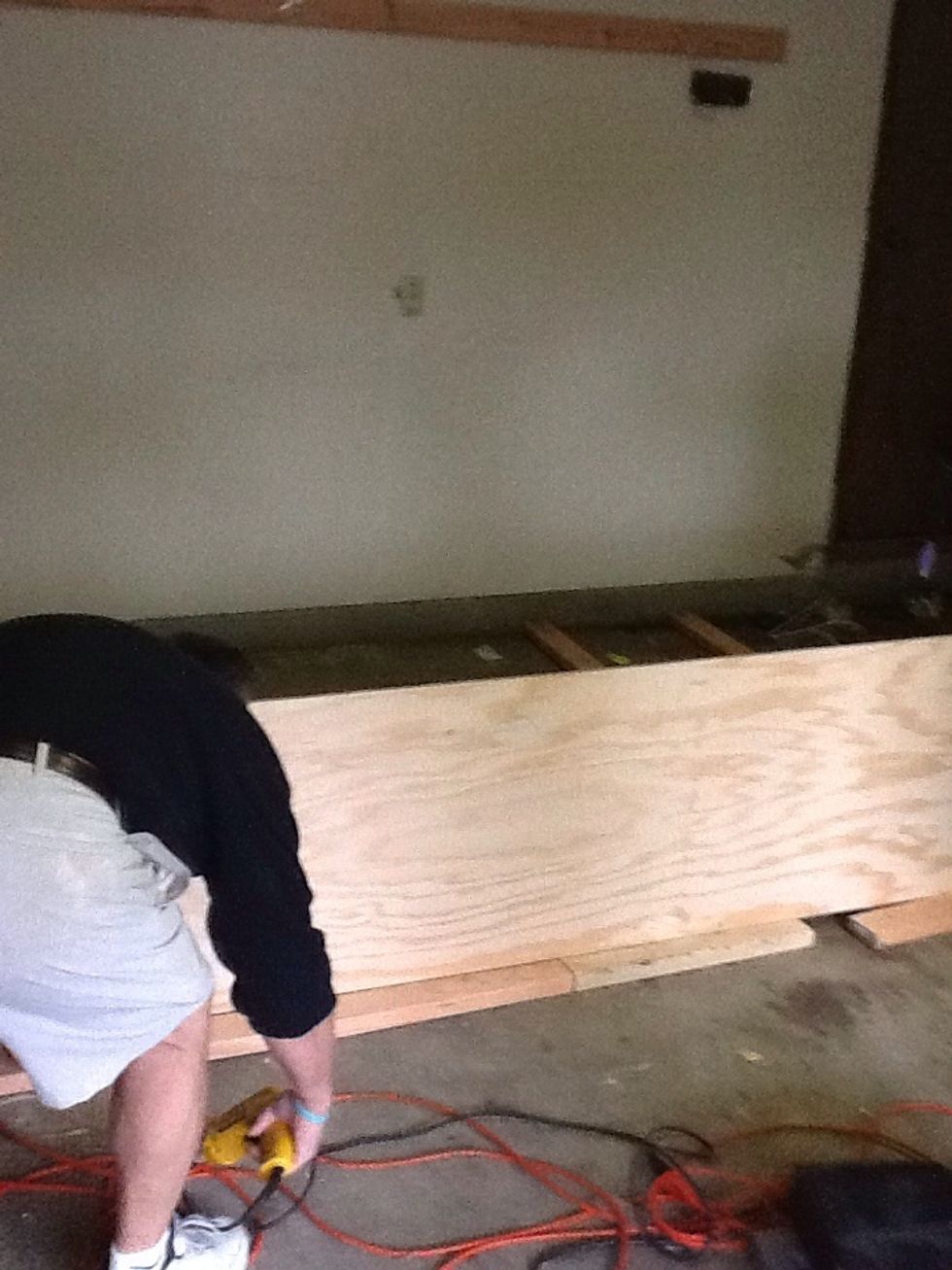 Tip: You can use 2x4 scraps or another stud to rest the top shelve on while screwing it into the frame. This sits the exact same height off the floor that you will need to rest.