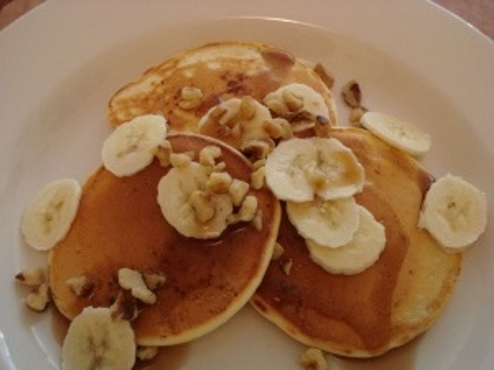 Tips to make your pancakes more healthy and fun. Add cut up fruit to the tops of your already cooked pancakes. In the picture above shows cut up bananas.