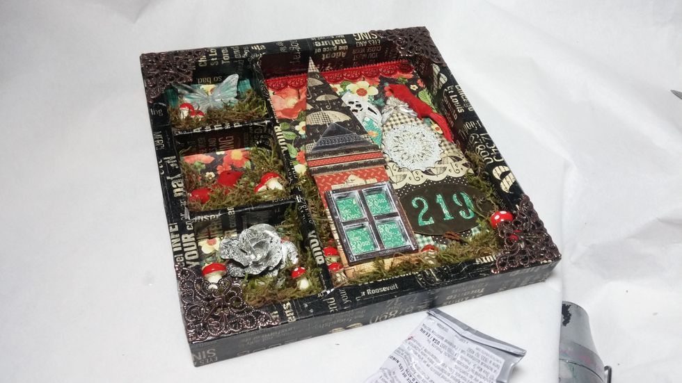 To add a finished edge, I glued down some metal filigree corners. I love how these frame out the assemblage.