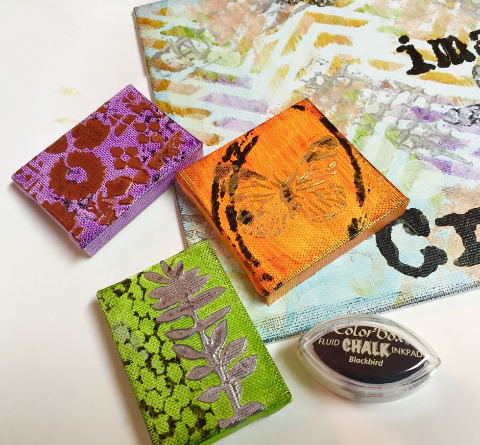 to add a little "distress" to the project and make the dimensional metallic designs stand out a little more, i rubbed Blackbird Chalk Ink along edges of designs and canvases using my finger to apply.