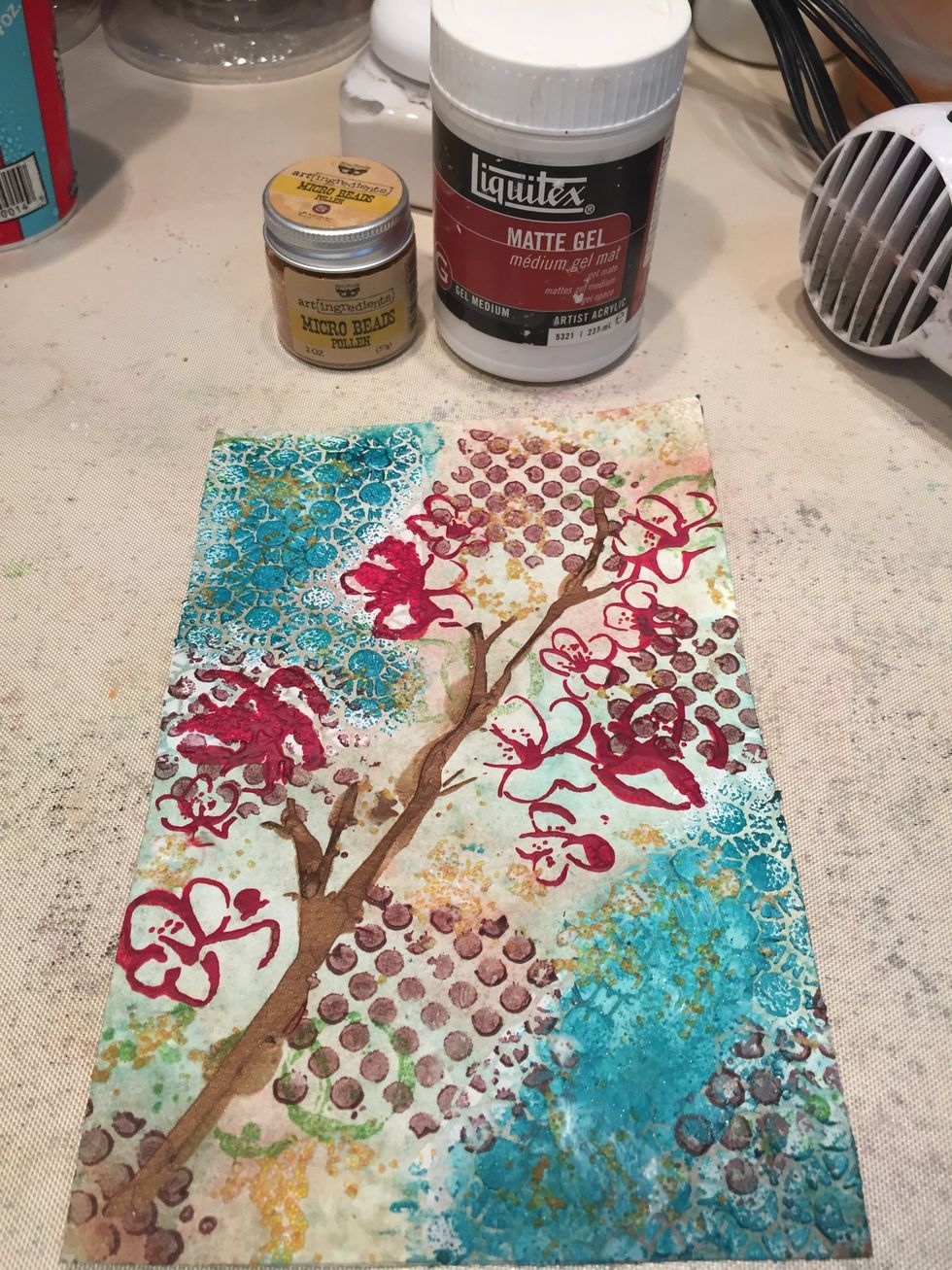 To add more texture, I mixed matte gel medium and pollen micro beads. I spread them across my page with a palette knife and my fingers. When dry, I sealed the page with matte gel medium.