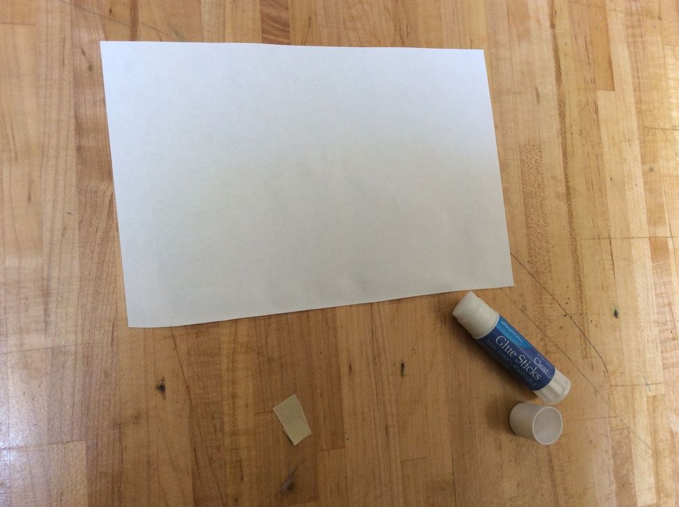 To add the pieces to the front and back of your book, first use your glue stick to put glue on one of the papers (around the edges and diagonally from corner to corner).