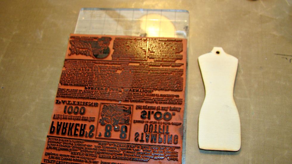 To alter my wooden dress form I stamped an image using black archival ink.