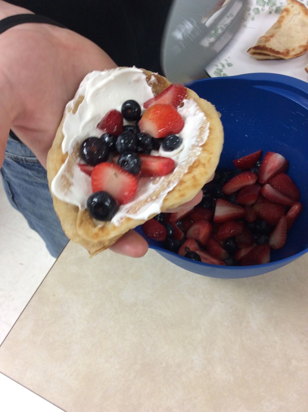 To assemble the tacos we first spread the whip cream on the inside of the shells. After that we add he fruit. Then we folded it together and they where ready to go
