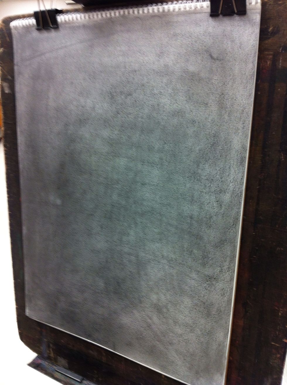 To begin the final drawing tone a sheet of drawing paper medium grey with graphite stick.