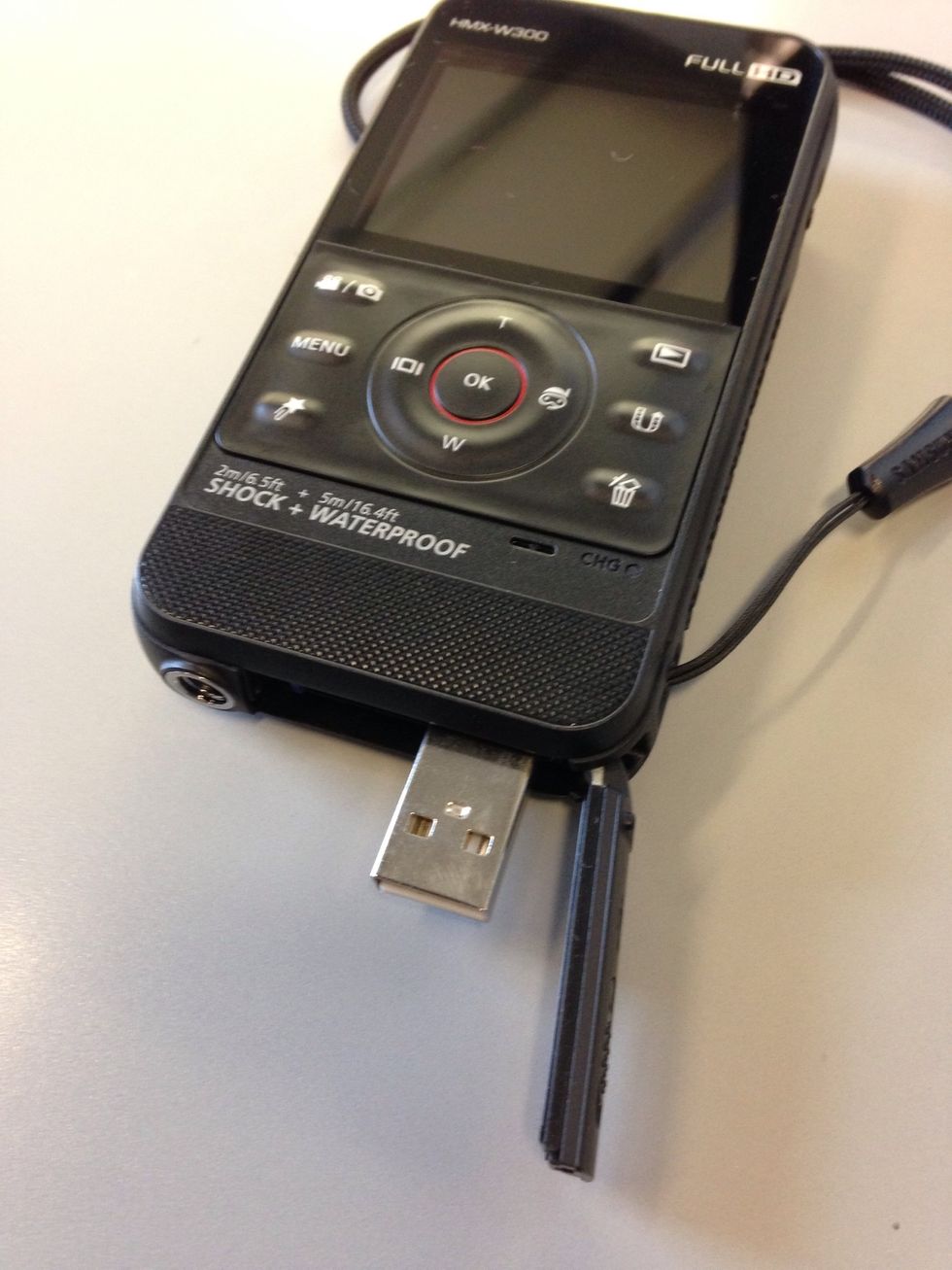 To charge or connect the camera to your computer, use the USB at the bottom of the camera. Slide the latch to release the USB connection to plug into your computer. .