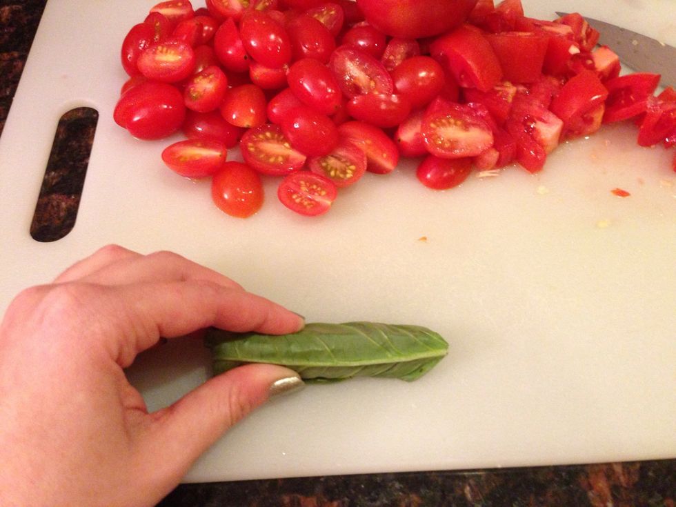 To chiffonade (slice into thin ribbons) your basil, stack the leaves into a pile and tightly roll into a cigar shape.