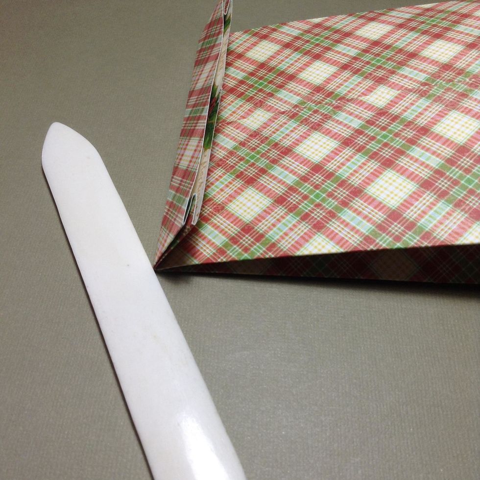 To close.. take the bag and check, the front must be flat, where there isn\u00b4t the join of the two sheets...take the top and fold back. To close this part you can use one sticker!