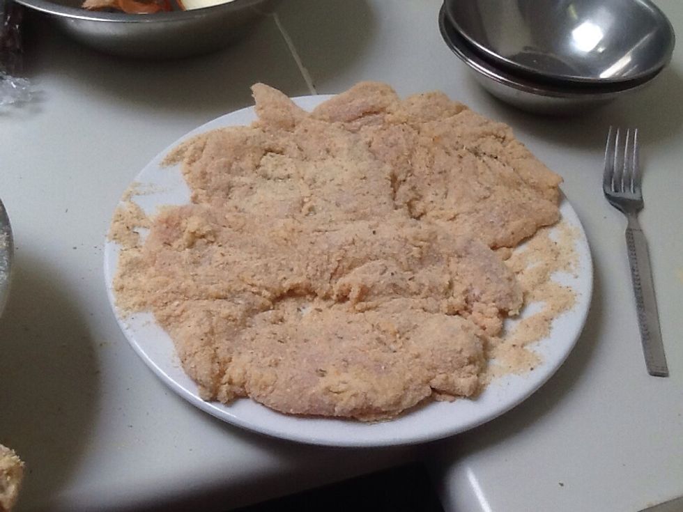 To coat the chicken. First place the chicken in the flour. Next place the floured chicken in the egg yolk. Finally place the chicken in the bread crumbs. Cover all of the chicken in each step