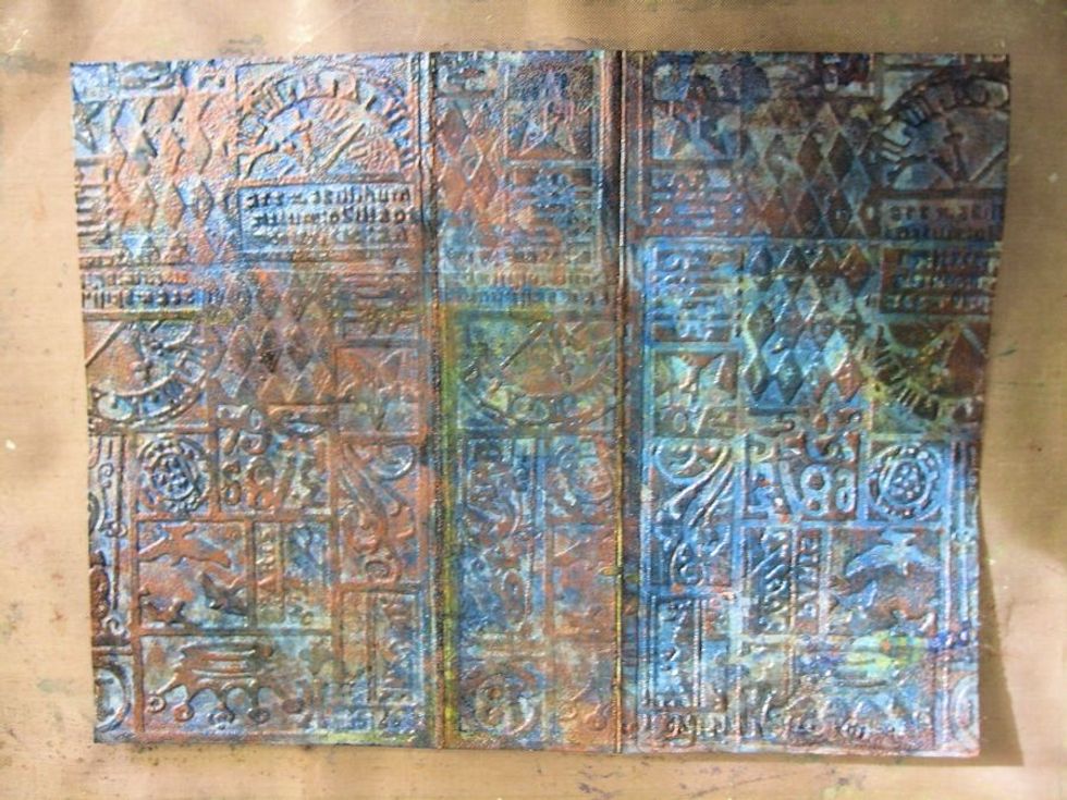 To complete the faux leather look, use a felt applicator to add Ranger Copper Mixatives to the embossed surface of the birthday planner cover.