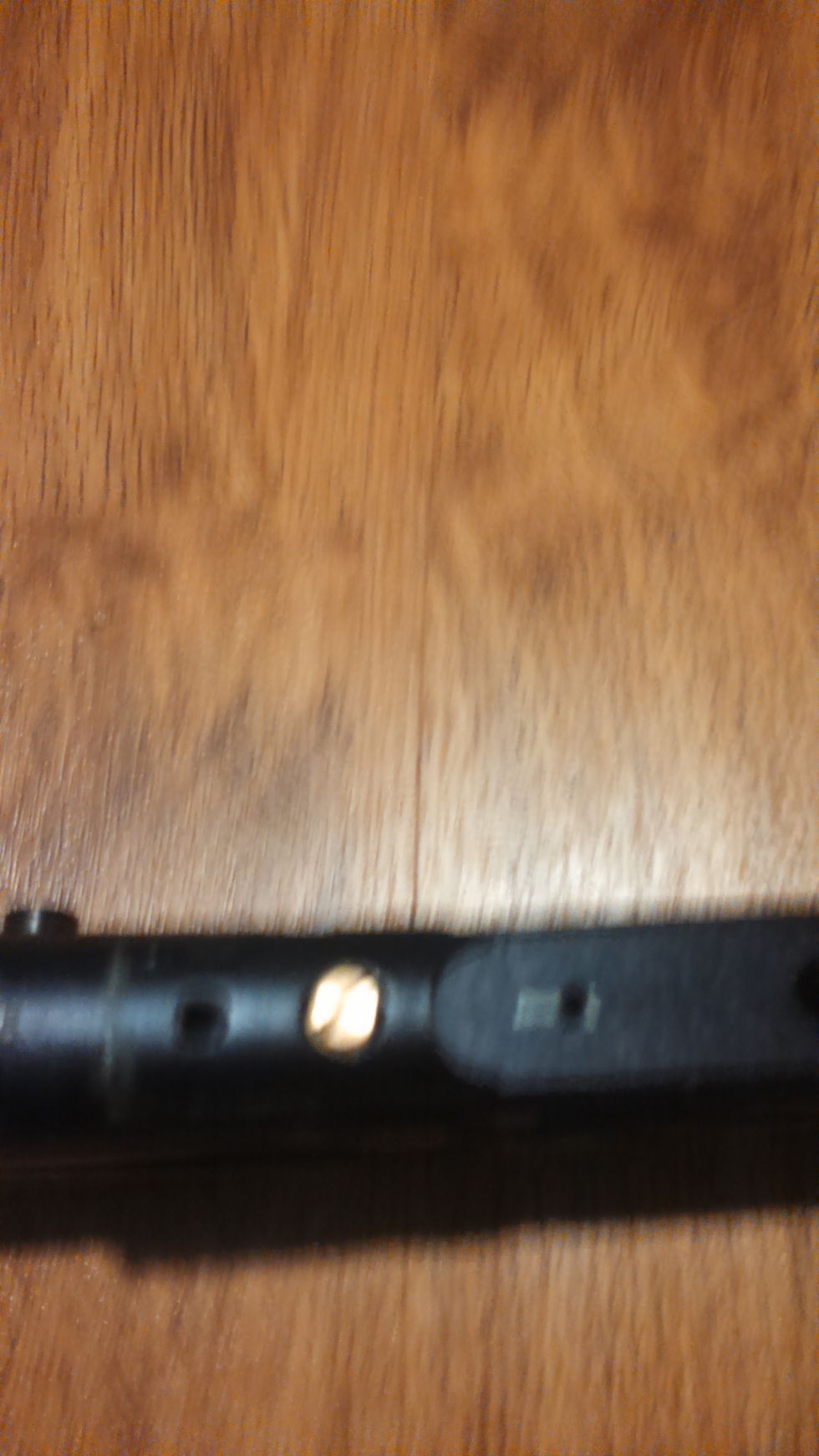 To completely clear the bottom chamber of the body this gold screw must be removed allowing the poppet housing to be removed. This is not necessary but allows for easier cleaning of the chamber.