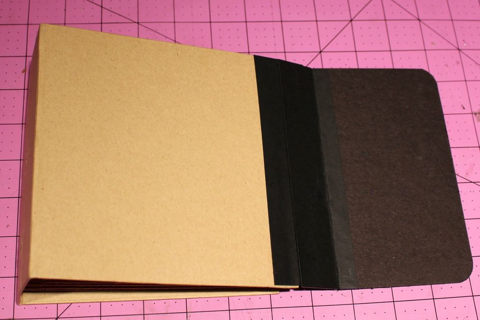 To connect the 2 pieces of chipboard to the album we are going to glue the 6" x 1 1/2" piece of cardstock scored at 1/2" the 1/2" will go to the black chipboard and the 1" side goes to the album side.