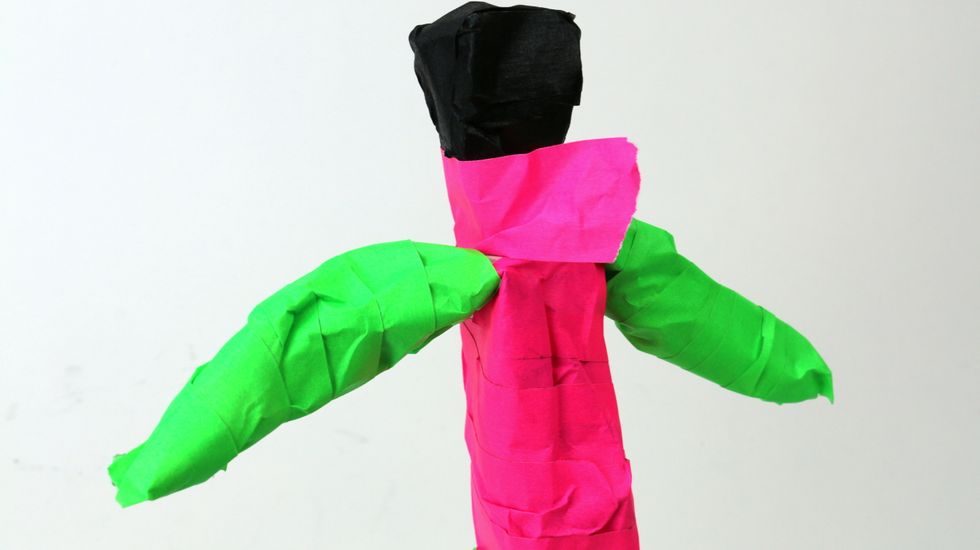 To cover the newspaper visible below the head, wrap a piece of tape around the neck.