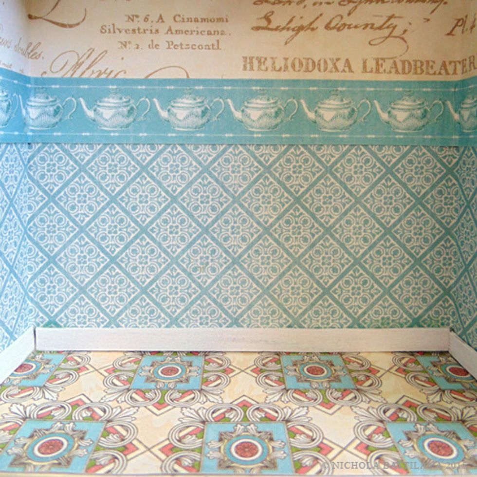 To create a more finished look I've added a border of teapots from Hello Friend. I've also added a baseboard made from coffee stir sticks which were painted white, cut to size, then glued into place.