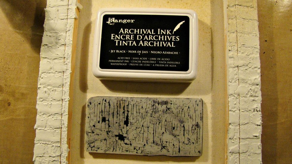 To create cracks in your brick covered canvas, use archival ink in black and this stamp is Andy Skinner's mixed media stamp.