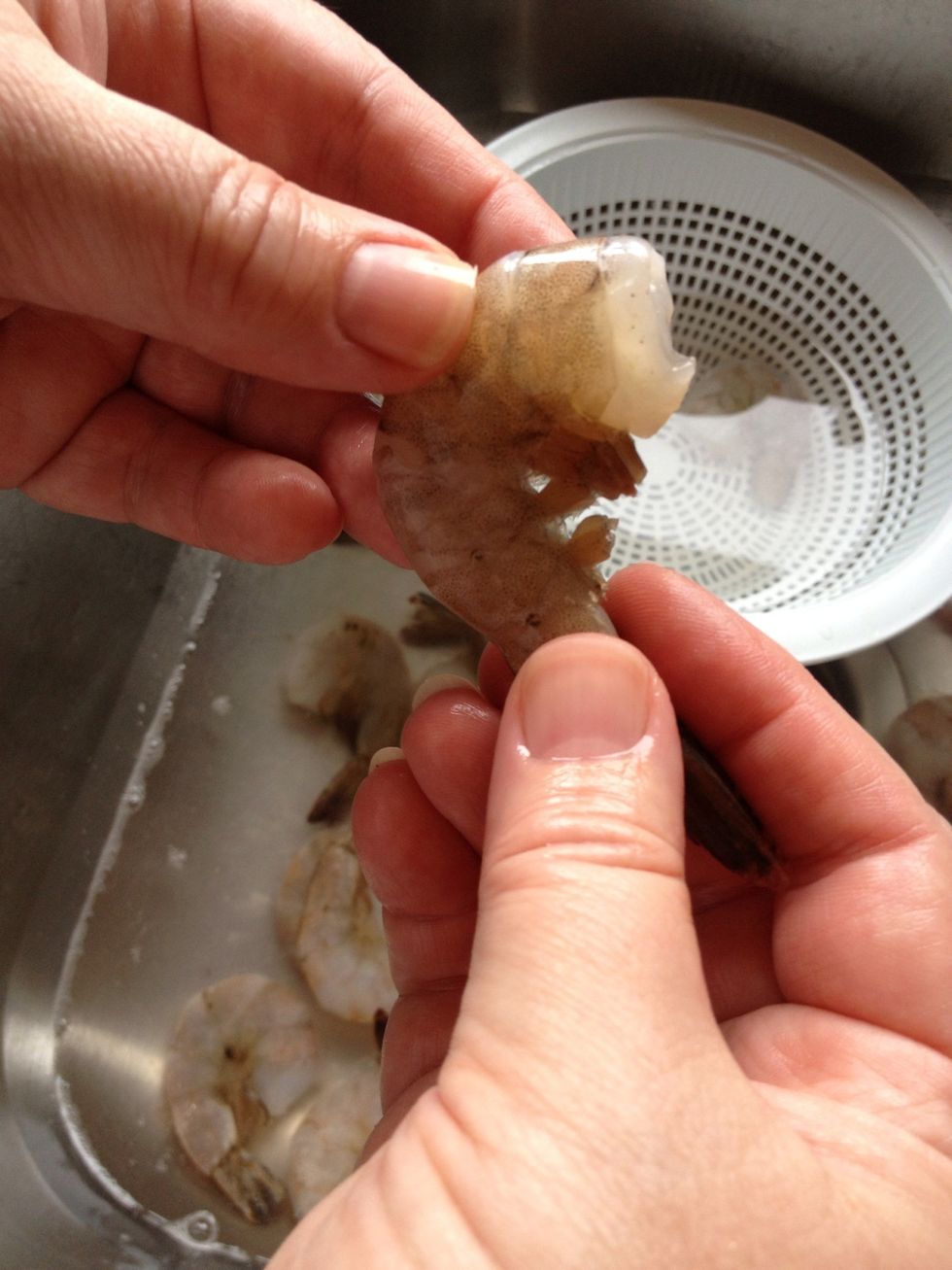 To devein shrimp make a shallow cut along the entire back and remove the black line. Then pinch the feet in the middle