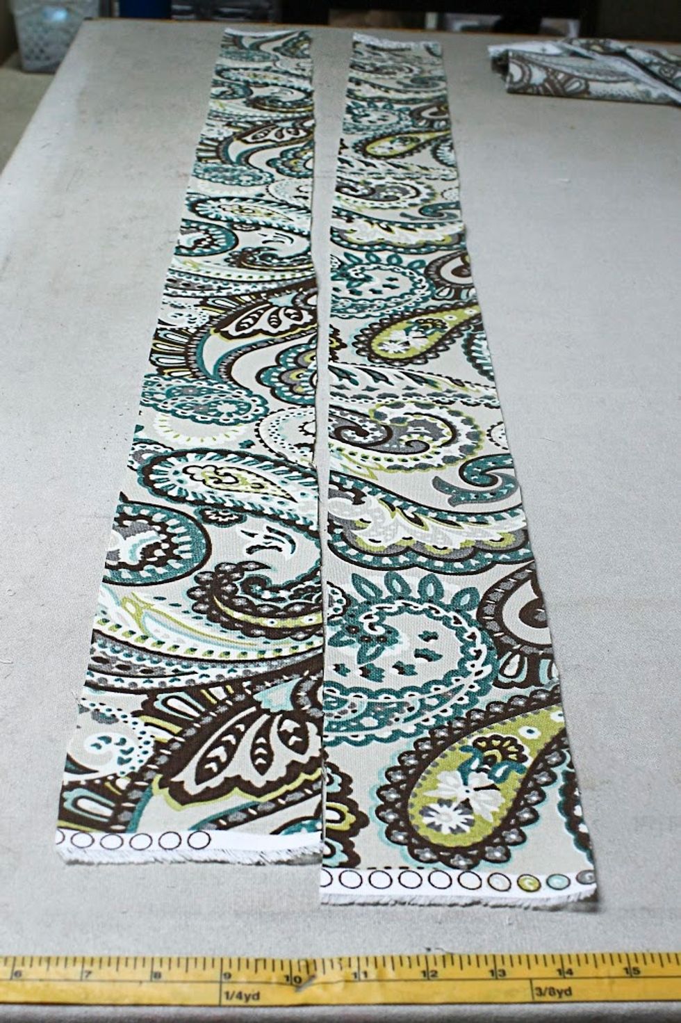 To do so, we cut two strips of fabric - each being the width of the foam plus 2" and the length of your cushion plus 6 inches to wrap around to the side.  My cushion was 42" so I cut mine 47" long