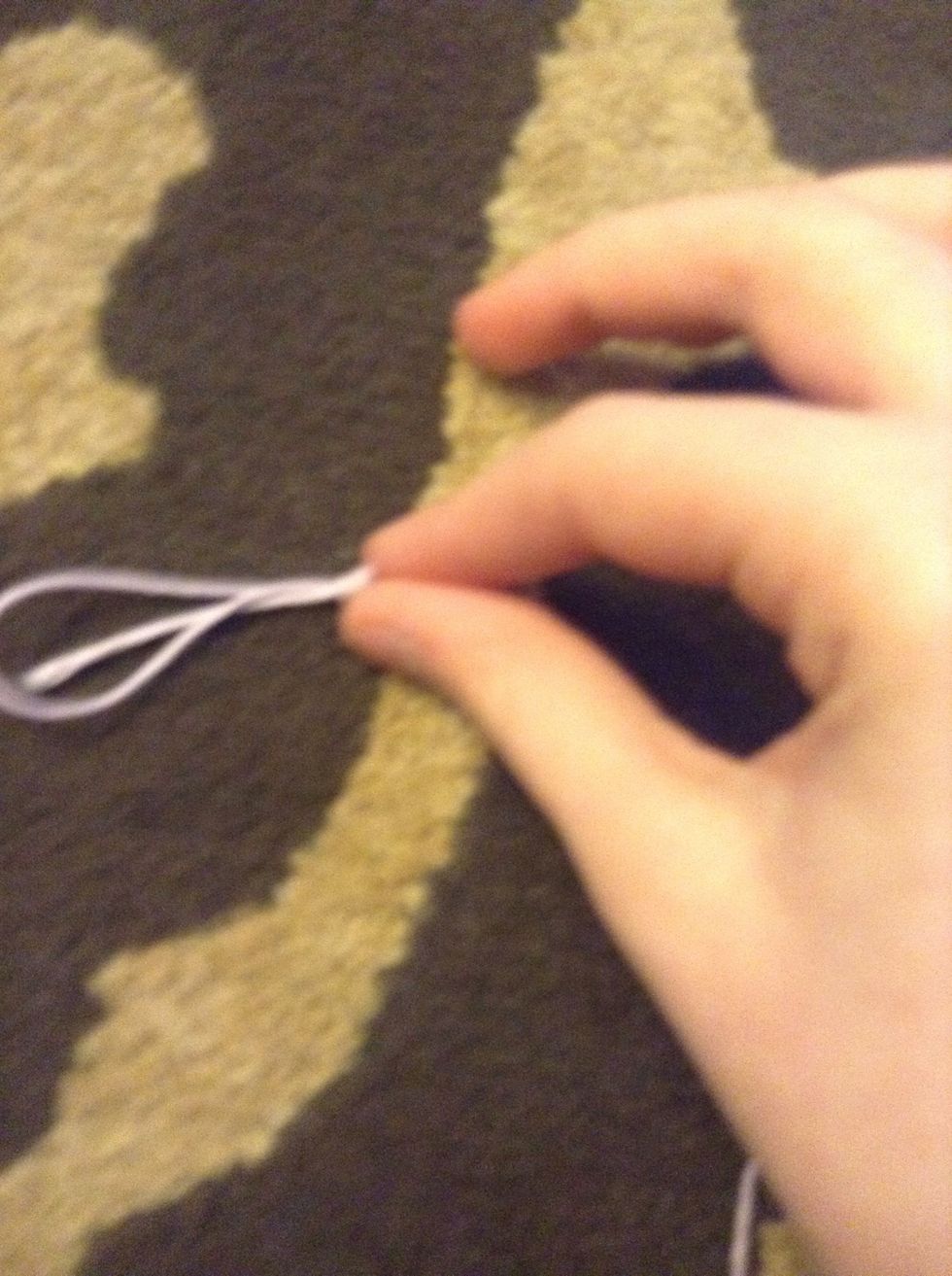 To do this knot you simply take all three of your strings a knot them together  do NOT tie at the tip top  leave rooms So the loop can form