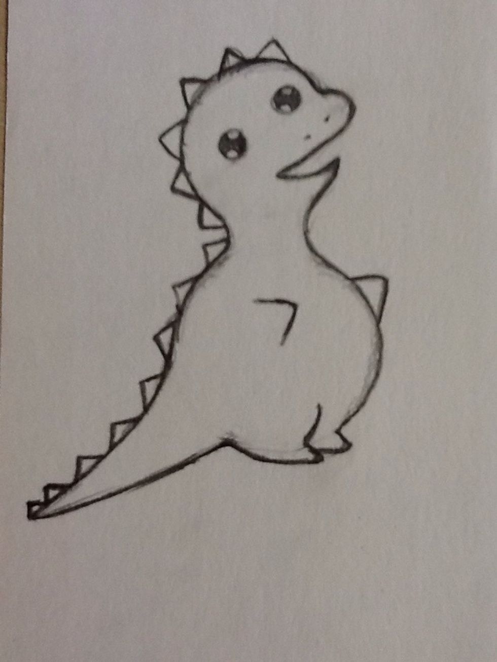 To draw the spikes, draw triangles along the top of the head, back and tail.