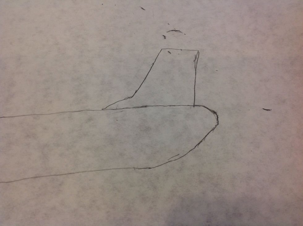 To draw the vertical stabilizer at the back, draw a curve similar to above, then draw a 2 inch line upward. Next, draw a 1.5 inch line across the top, followed by a 1.75 inch line down.