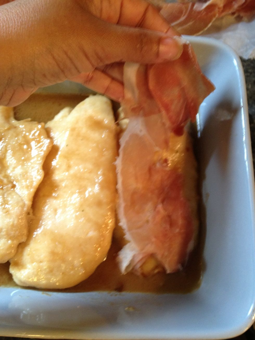 To each chicken piece add a slice of prosciutto. Prosciutto is expensive, don't go out and buy it  if you don't want to. Use ham it's cheaper. It will still taste amazing, I promise \ud83d\ude00