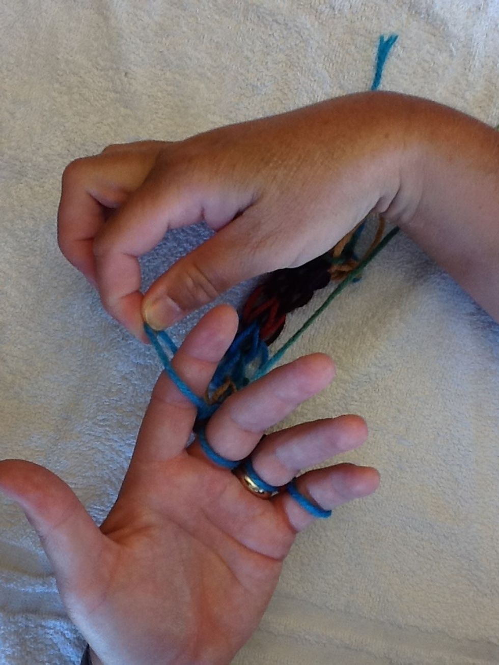 To end your finger knitting, start with your ring finger and move the loop over to the middle finger.