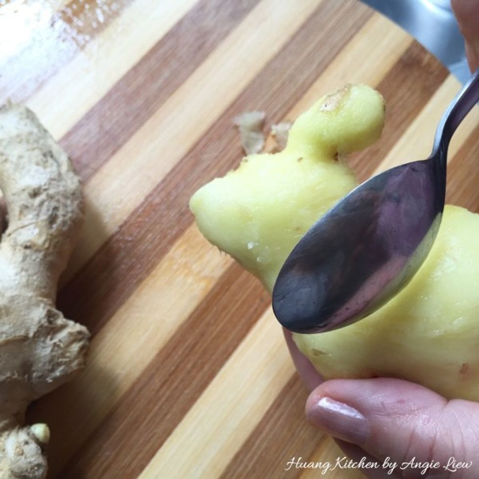 To express ginger juice, first scrape the edge of a metal spoon against the ginger to peel off the skin.