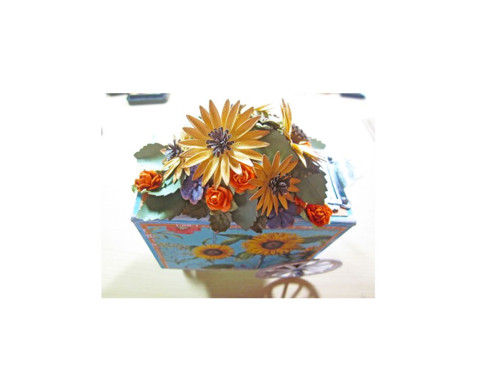 To fill in some of the spots & to add a bit more interest use several other flowers.  I used flowers by Petaloo in purples and oranges to add in.  The mixed colors look beautiful and match the paper.