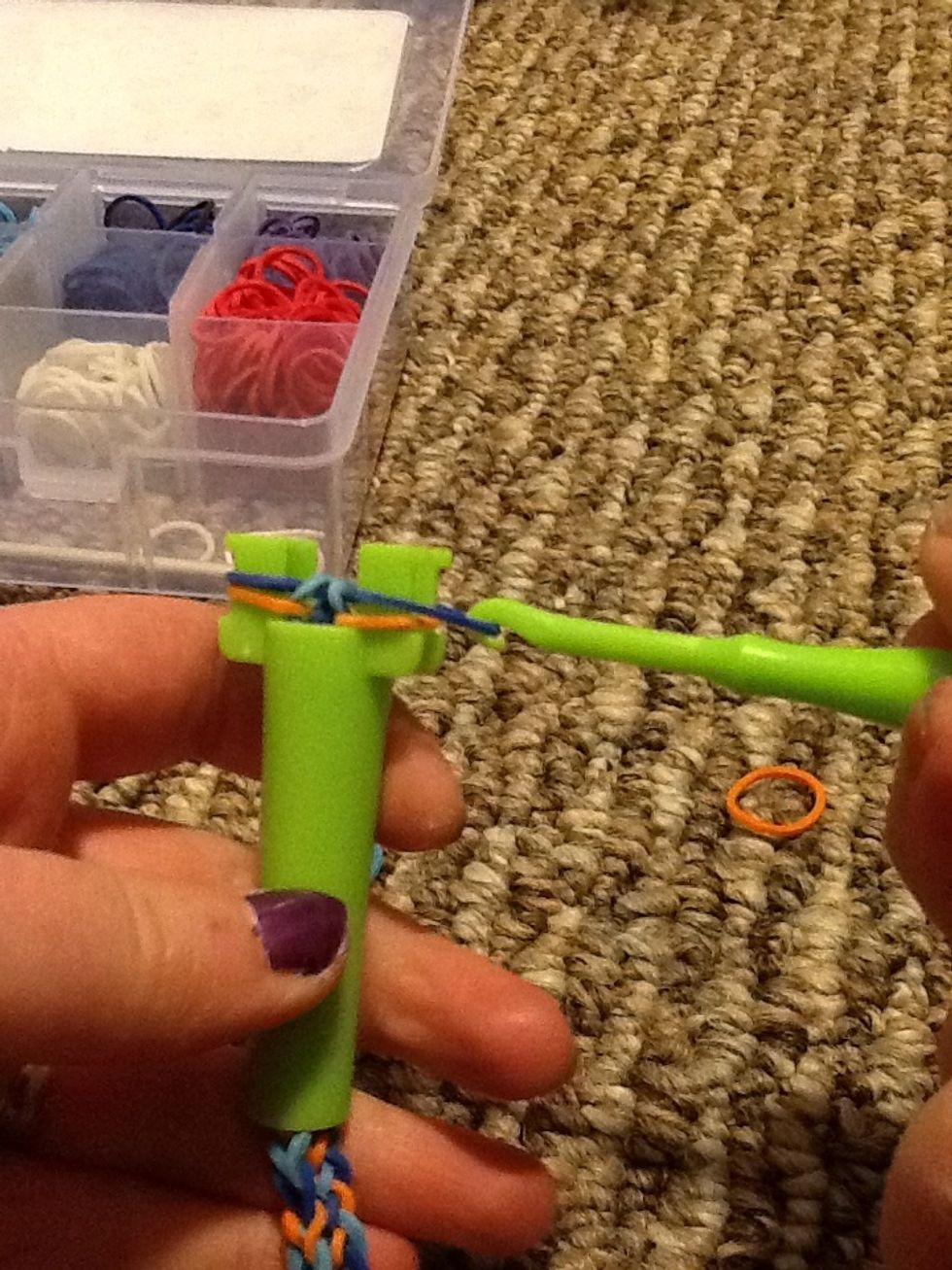 To finish it off, you're going too pull out the top band, put it under the bottom band, and lift the bottom band over the top (like the other steps only with 2 bands).